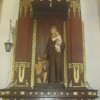 St. Anthony of Padua carrying baby Jesus with a kneeling man in front