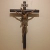 The crucifix on the front wall of children's area. The wood that constitutes the cross seems cylindrical like bamboo.