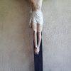Crucifix in San Pedro Bautista Parish A crucifix on a wooden stand is inside the San Pedro Bautista Parish. The brown stand has two levels, with the upper level smaller than the lower one. The cross is of a darker shade of brown compared to the stand. In this statue, Jesus has pale skin color and wrapped by a cloth around the waist. He has dark brown hair and facial hair and wears a dark green crown of thorns.
