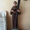 St. Peter Baptist statue A statue of St. Peter Baptist on a wooden stand inside the San Pedro Bautista Parish. St. Peter is wearing a brown robe with a rope belt typical to that of Franciscans. He is carrying a large cross made of cylindrical woods with his right hand.