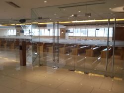 The exterior of Chapel of St. Padre Pio in Shangri La EDSA. Only glass walls divide the chapel from the main passage of the mall. The pews are visible and so does the buildings outside through the glass windows on the other side.