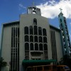 The facade of San Isidro Labrador Parish is mostly white with cyan highlights. It has two crosses, one on the top center and the other on the right (if you are facing the church) on top of a thinner cyan bell tower. The church has twelve semi-oblong windows on the central protrusion and several rectangle windows on both sides.