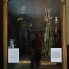 Statues of San Isidro Labrador and Sta. Maria Dela Cabeza inside a glass cabinet. On the glass near the foot of the statues are two papers containing prayers to each of them. On the wooden parts are another set of papers containing petition/thanksgiving letters: two papers for each of them.