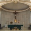 Altar of Sta. Rita de Cascia Parish Sanctuary with green cloth on the altar, green pillars on the side, and rectangular tabernacle under the crucifix.