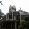 Structure of Sta. Rita de Cascia Parish. It has circular glass stained at the middle above the main entrance and has bells under the cross.