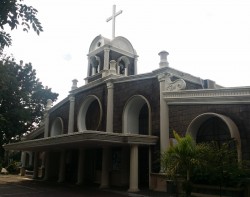 Structure of Sta. Rita de Cascia Parish. It has circular glass stained at the middle above the main entrance and has bells under the cross.