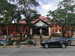 The facade of Sto. Niño De Congreso are different shades of red, with the triangular roof more on the side of maroon, while the walls are more like red-orange. The roof is triangular with a cross on top, while the wall has several rectangular windows. The church is on elevated earth with ramp access on both sides for vehicles and a staircase that leads to the church's main entrance at the middle: a large Sto. Niño statue is in the middle of the staircase, elevated on a pedestal.